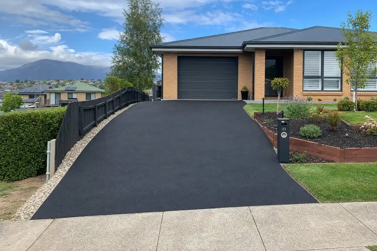 Freshly laid asphalt driveway at a Hobart residential property with compacted road base visible at the edge