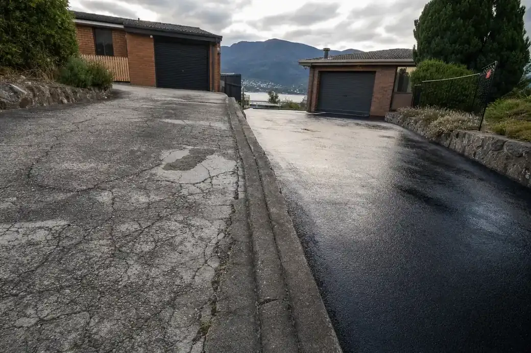 Comparison of a tired asphalt driveway surface before and after a seal coat treatment in Hobart